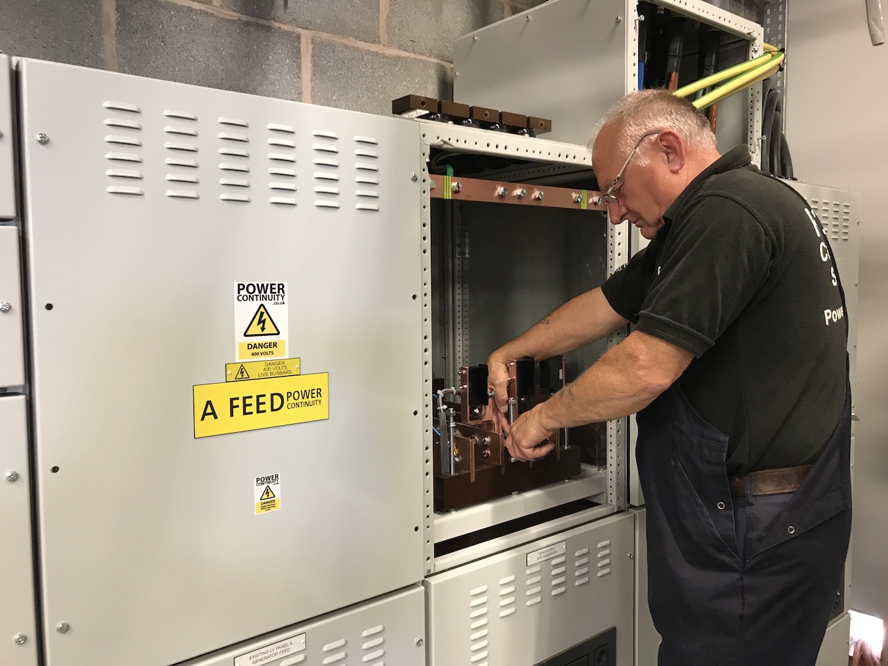 power continuity engineer working on a lv mains panel.JPG